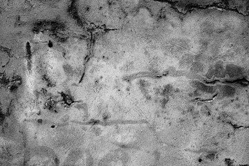 Texture of a concrete wall with cracks and scratches which can be used as a background