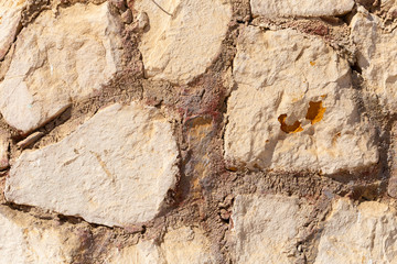 Fototapeta premium Background of limestone masonry. The surface is decorated with natural material. The wall is made of wild stone.
