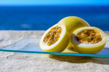Fresh ripe yellow  passion fruit on blue sea background