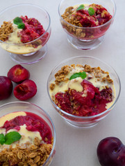 Fresh bright red plum crumble in the dessert bowl