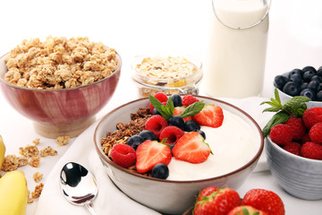 Tasty homemade granola served on table. Healthy breakfast with a bowl of oatmeal with banana, blueberries, strawberries and healthy food for Breakfast