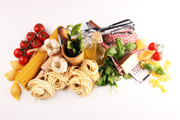 Pasta, vegetables, herbs and spices for Italian food on rustic table