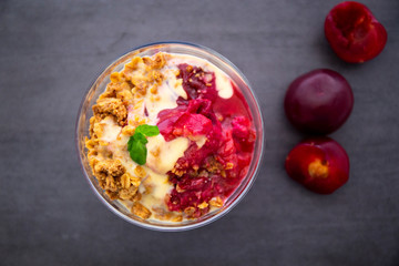 Fresh bright red plum crumble in the dessert bowl