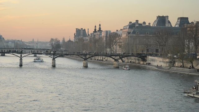 View towards Pont des Arts on the river Seine as a cruise ship passes under it, Paris, France