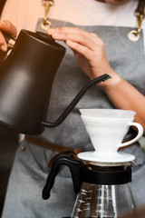 Close-up drip coffee. Barista pouring water over the coffee powder.