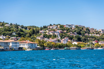 Fototapeta na wymiar Beautiful builings and mansions at the costline and hillslope with green forest in summer, at Bosphorus Strait in Istanbul,Turkey. View from a Cruise Ship.