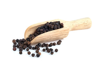 Black pepper with wooden scoop on white background