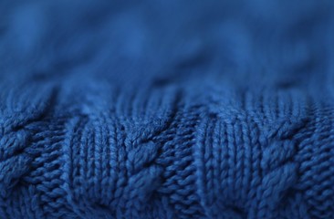 Seamless knitted fabric with pigtails. Knitted sweater, plaid, scarf. Knitted background. Classic Blue color 2020