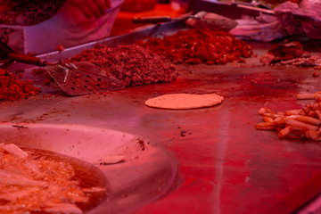street tacos and french fries being cooked in a street market