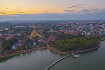 Fototapeta premium Aerial view eastern Khon Kaen cityscape with Phra Mahathat Kaen Nakhon, Wat Nong Wang at sunset sky in Thailand.