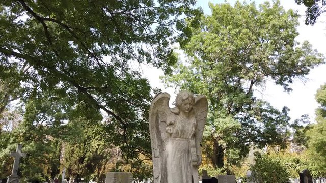 Statue of an angel in a cemetery. Funeral concept. Angel statue on gravestone.