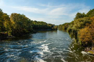 Fototapeta na wymiar Scenic panorama of river flowing between the banks