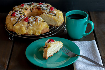 front view of portion of chocolate-dipped Easter thread with cherries and custard and a cup of coffee