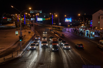 Fototapeta na wymiar Night road with cars in the city. Christmas city with bright lights. Minsk Belarus. December 31 2019