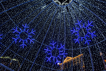 Christmas night neon glowing cityscape. Buildings with decorations and lamps. Minsk Belarus. December 31 2019