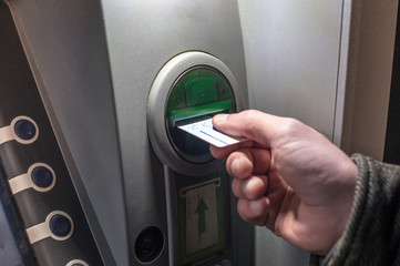 man inserting credit cart to atm