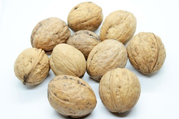 Ripe walnuts located on a white background