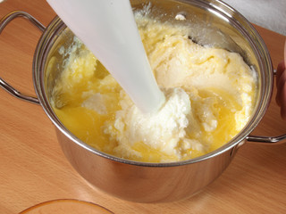 Mixing melted butter and cheese cream. Making Chocolate Layer Cake with Cream Cheese Filling and Chocolate Topping. Series.