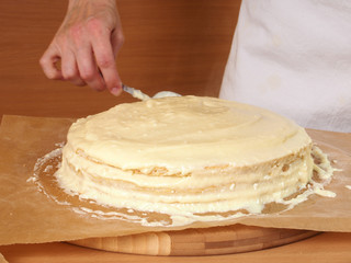 Filling cake layers. Making Chocolate Layer Cake with Cream Cheese Filling and Chocolate Topping....