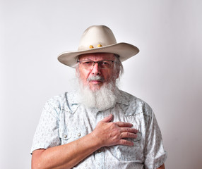 Old Caucasian man with a long white beard showing extreme physical pain. Concept of medical problems old people suffer from, including extreme pain.