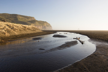 The river, black sand, dunes and mountains of Karekare Beach in West Auckland, New Zealand.