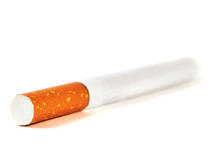 One cigarette lies with a filter to us on a white background