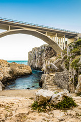 The Ciolo bridge, which connects two high cliffs, in an inlet of the sea, in Gagliano del Capo, near Santa Maria di Leuca, in Salento. In the evening, at sunset, in the winter. Puglia, Italy.