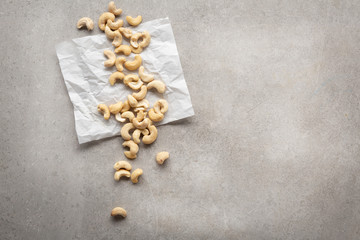 Fototapeta na wymiar Fresh organic cashew nuts top view on concrete
