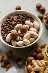 Fresh set of assorted nuts in bowls, pine nuts and hazelnuts