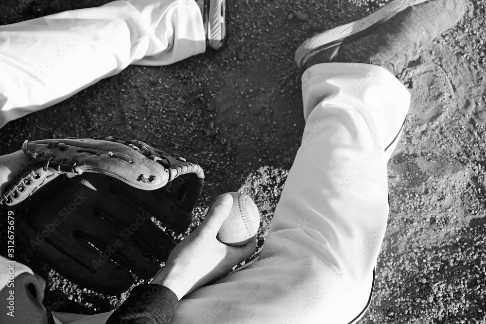 Canvas Prints Baseball player sitting on field in black and white with mitt and ball for game. - Canvas Prints