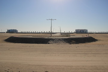 Empty circle road curl in desert in bright sun 