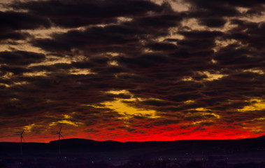 A very extraordinary and beautiful sunset in orange and purple colours, lightened and bright