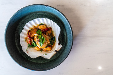 Scallops on the half shell with chilli and basil