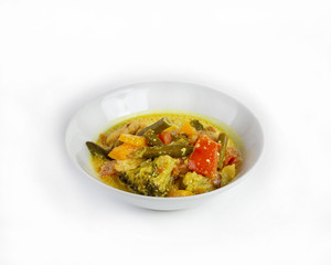 Thick soup with chicken and vegetables on a white background