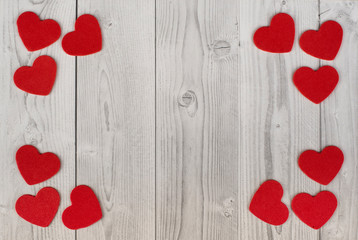 Fototapeta premium red hearts in the corners of a white and grey wooden background. concept of valentine's day
