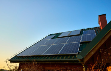 Solar panels and solar collectors on the roof of a wooden building