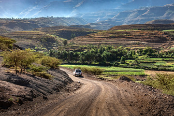 ETHIOPIA, LALIBELA, 01-31-2019. 4 wheel drive car on its way through a spectecular mountain scenery...