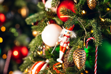 Obraz premium Decorated European American Christmas tree red and green color, close-up of toys and decor striped candy