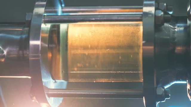 Craft beer brewing. Filtration of brewed beer. Brewing equipment in action. Close-up. Craft beer brewing. Filtration of brewed beer. Brewing equipment in action