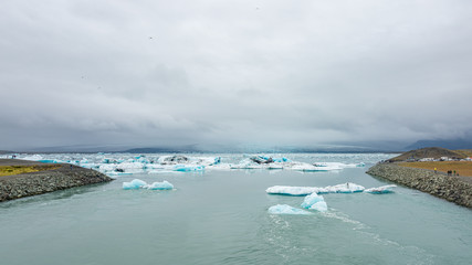 Touristic activity in Glacier Lagoon Jokulsarlon with icebergs in Iceland, summer