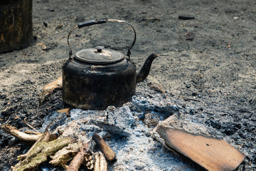 Extinguished fireplace with a teakettle
