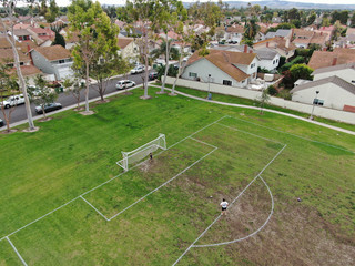 Suburban packed homes neighborhood with small park and soccer field. Vast subdivision in Irvine,...