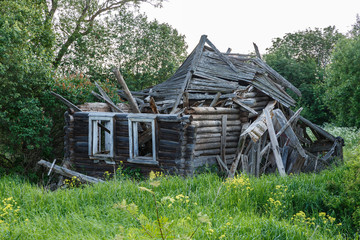 Fototapeta na wymiar Abandoned destroyed wooden house in small russian village