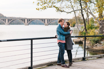 Couple embracing along the boardwalk in Georgetown, Washington DC