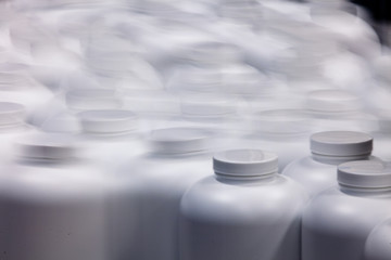 Blurred motion pill bottles on pharmaceutical production line