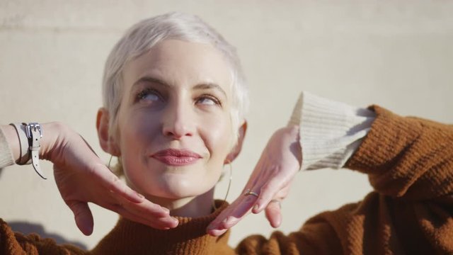 Close up portrait of female model posing to camera, in slow motion 