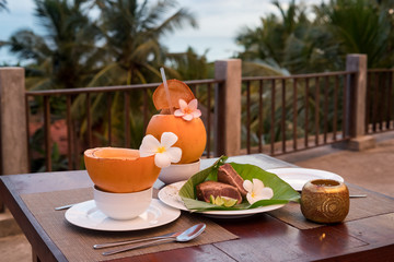 Delicious asian food served on the terrace with coconuts