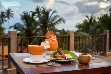 Delicious asian food served on the terrace with coconuts