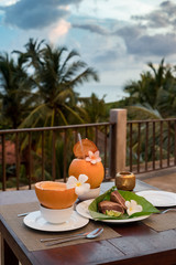 Delicious asian food served on the terrace with coconuts