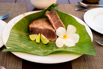Delicious tuna steak with lime in a banana leaf